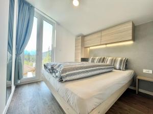 a bedroom with a large bed with a large window at Holiday Home SKY Chalet by Interhome in Imst