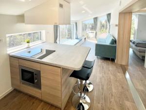 a kitchen with a sink and a living room at Holiday Home SKY Chalet by Interhome in Imst
