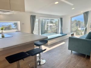 a kitchen and living room with a large window at Holiday Home Sky-Chalet by Interhome in Imst