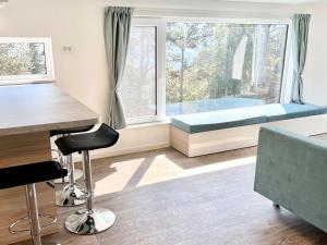 a room with a bed and a desk and a window at Holiday Home Sky-Chalet by Interhome in Imst
