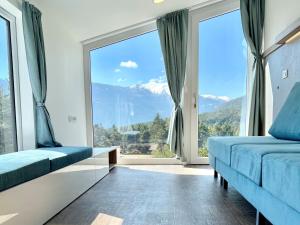 a room with two beds and a large window at Holiday Home Sky-Chalet by Interhome in Imst