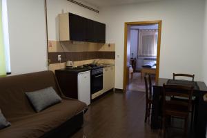 a living room with a couch and a kitchen at Apartment Eurho in Osijek