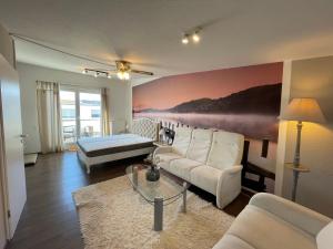 a living room with a couch and a bed at Holiday Home Knapp by Interhome in Breisach am Rhein