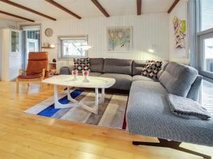 a living room with a couch and a table at Holiday Home Igilfar - 700m from the sea in Western Jutland by Interhome in Vejers Strand