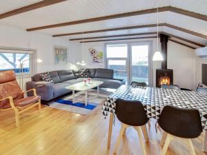 a living room with a table and a couch at Holiday Home Igilfar - 700m from the sea in Western Jutland by Interhome in Vejers Strand