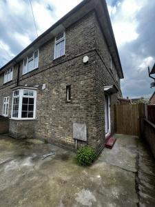 a brick house with a lot of windows at Good priced Double Rooms in Sherperds bush in London