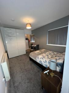 a hotel room with a bed and a desk and a table at Apt 3. Private Studio in Moseley, Birmingham in Birmingham