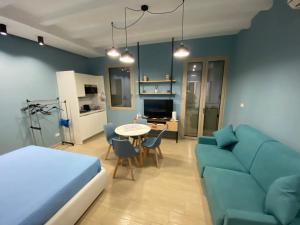 a room with a bed and a couch and a table at Ca Sà Bellò San Vito Lo Capo in San Vito lo Capo