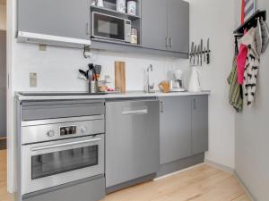 a kitchen with stainless steel appliances and a microwave at Apartment Jaakko - 100m from the sea in Western Jutland by Interhome in Fanø