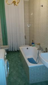 a bathroom with a bath tub next to a sink at Apartment Angioletta in Manfredonia