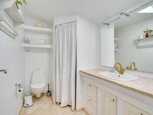 ein Badezimmer mit einem Waschbecken, einem WC und einem Spiegel in der Unterkunft Holiday Home Aswin in SE Jutland by Interhome in Silkeborg