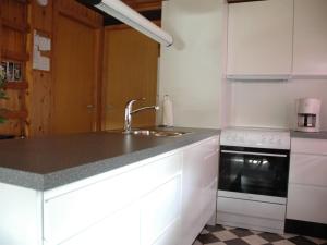 a white kitchen with a sink and a stove at Holiday Home Nilda - 1km from the sea in Western Jutland by Interhome in Vejers Strand