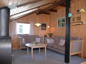 a living room with a couch and a table at Holiday Home Nilda - 1km from the sea in Western Jutland by Interhome in Vejers Strand