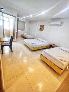 Postel nebo postele na pokoji v ubytování Hotel Palermo Sincelejo