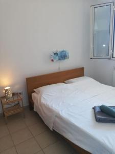 a bedroom with a white bed and a window at Grazioso appartamento terrazzo e wi-fi near Otranto in Casamassella