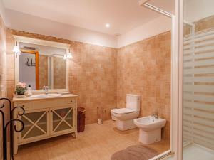 a bathroom with a toilet and a sink and a shower at Holiday Home Cas Moliner by Interhome in Petra +20 photos