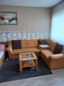 a living room with a couch and a coffee table at Ferienwohnung Conny am Südstrand Familie Bach in Burgtiefe auf Fehmarn 