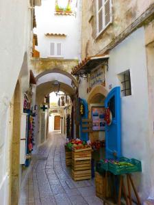 an alley with an archway in a city with a market at Divina Casa Vacanze Donna Filomena in Sperlonga