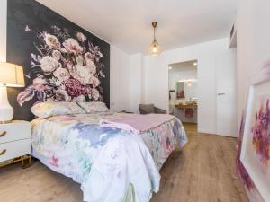 a bedroom with a bed with a floral wall at Apartment Barcelona by Interhome in Torredembarra
