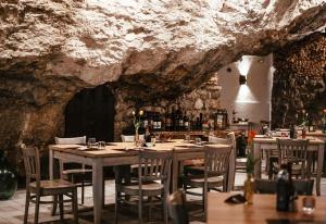 a restaurant with a table and chairs in a cave at La Cantinota - Locanda De Manincor Rooms in Arco