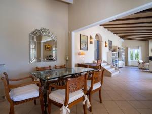 a dining room with a glass table and chairs at Villa Marita by Interhome in Moraira