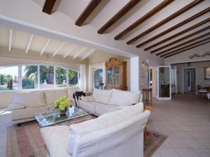 a living room with white furniture and a large window at Villa Marita by Interhome in Moraira