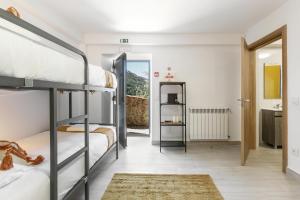 a room with two bunk beds and a hallway at Maria da Vinha - Country House in Góis