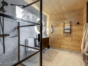 a bathroom with a shower and a glass door at Holiday Home Saunamäki resort villa n in Särkisalo