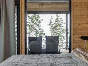 a bedroom with a bed and a large window at Holiday Home Saunamäki resort villa n in Särkisalo