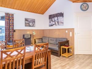 a living room with a couch and a table at Holiday Home Tahkon alppitalo 4 as- 3 by Interhome in Tahkovuori