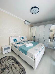 a bedroom with a large bed and a mirror at Apartament lux in Chişinău
