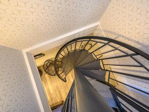 a spiral staircase in a house with a ceiling at Apartment La Meunerie-1 by Interhome in La Trinité-sur-Mer