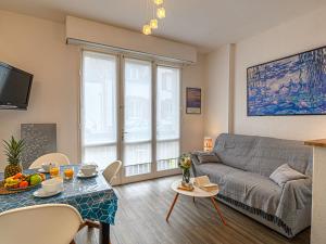 a living room with a couch and a table at Apartment La Meunerie-1 by Interhome in La Trinité-sur-Mer