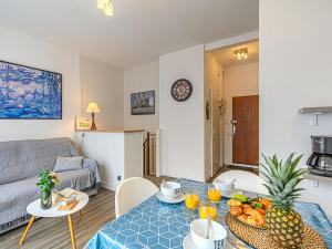 a living room with a table with a bowl of fruit on it at Apartment La Meunerie-1 by Interhome in La Trinité-sur-Mer