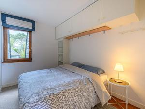 a small bedroom with a bed and a window at Apartment Le Quai by Interhome in La Trinité-sur-Mer