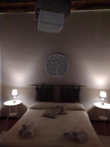 a bedroom with a bed with two lamps on it at L'Ulivo in Villa Greco in Tindari