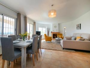 a dining room and living room with a table and chairs at Holiday Home Mazo by Interhome in Benissa