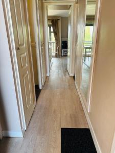 a hallway of a house with wooden floors and doors at La Résidence du Golf de Deauville in Deauville