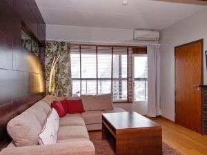 a living room with a couch and a table at Holiday Home Tahko spa junior suite orange a 10 by Interhome in Tahkovuori