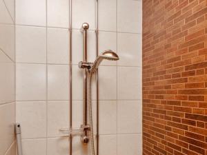 a shower with a shower head in a bathroom at Holiday Home Tahko spa junior suite orange a 10 by Interhome in Tahkovuori