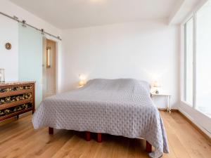 a white bedroom with a bed and a dresser at Apartment Le Parc Cordier-6 by Interhome in Trouville-sur-Mer