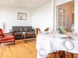 a living room with a table and a couch at Apartment Le Parc Cordier-6 by Interhome in Trouville-sur-Mer