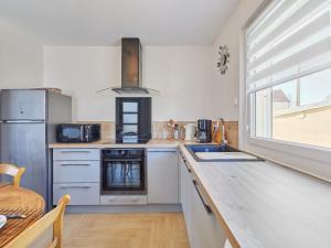 a kitchen with a sink and a counter top at Holiday Home Janomaine by Interhome in Cabourg