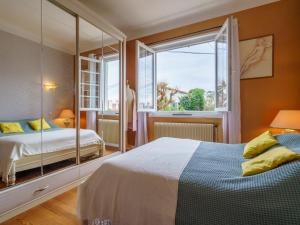 a bedroom with a bed and a large mirror at Holiday Home Milady II by Interhome in Biarritz