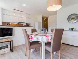 a kitchen and dining room with a table and chairs at Apartment Domaine des roches by Interhome in Trouville-sur-Mer