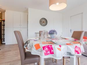 a dining room with a white table and chairs at Apartment Domaine des roches by Interhome in Trouville-sur-Mer +13 photos