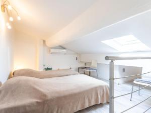 a bedroom with two beds and a skylight at Studio Rue Allard by Interhome in Saint-Tropez