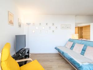 un soggiorno con un divano blu e una TV di Apartment Port Arcachon-5 by Interhome ad Arcachon