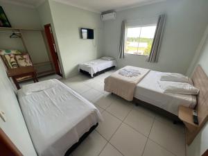 Voodi või voodid majutusasutuse HOTEL EXPRESS LORENZETTI toas +4 fotot