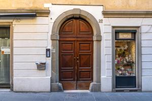 een grote houten deur op een gebouw naast een winkel bij Centro storico · Leonardo House in Bergamo